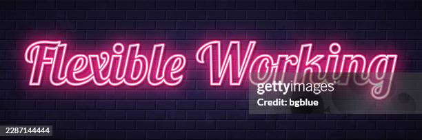 flexible working - glowing neon text on brick wall background - flexible clinker stock illustrations