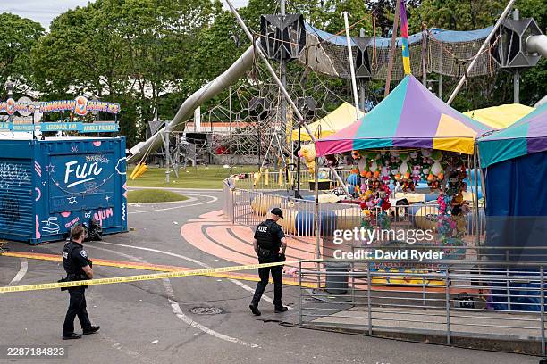 Police officers walk on patrol at the scene of a mass shooting at the Bite of Seattle food festival on July 26, 2026 in Seattle, Washington. At least...