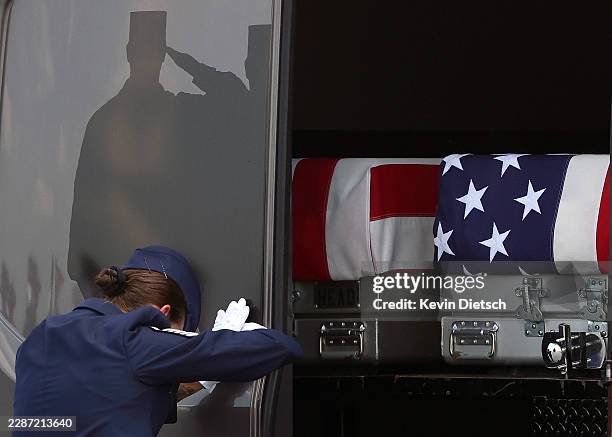 Door marshaller closes the door as the transfer cases containing the remains of U.S. Army 1st Lt Tyler Feehan and U.S. Army Staff Sgt. Michael...