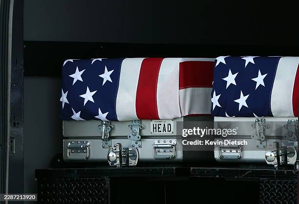 The flag-draped transfer cases containing the remains of Army 1st Lt. Tyler James Feehan and Staff Sgt. Michael Emmanuel Swinton are seen during a...