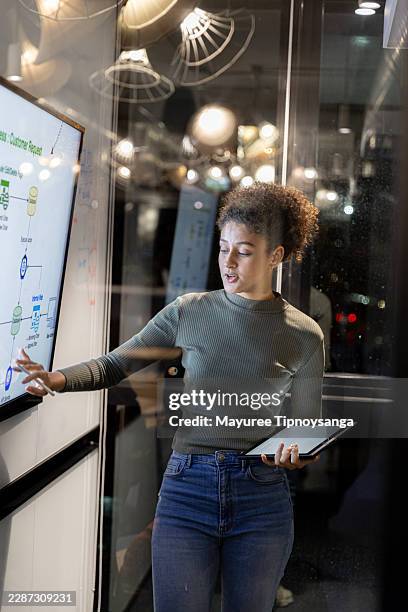 software engineer presenting system architecture on interactive display during technical team briefing - security devops stock pictures, royalty-free photos & images