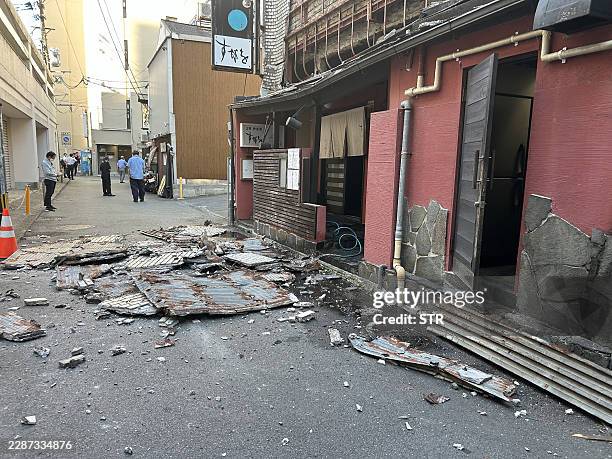 The exterior wall of a shop is seen collapsed in an earthquake, in Kumamoto City on July 28, 2026. / Japan OUT