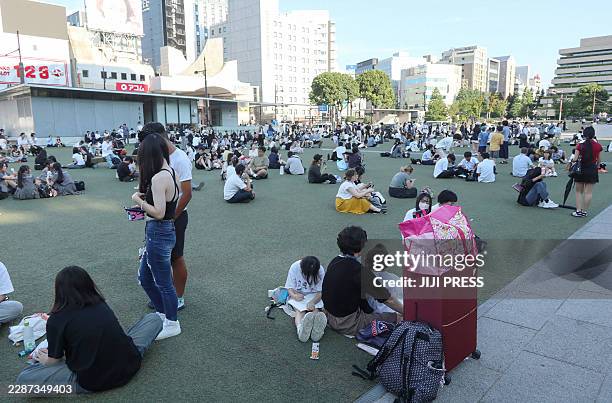People wait in a park after evacuating buildings following a strong earthquake in Kumamoto City, Chuo Ward on July 28, 2026. A major earthquake...