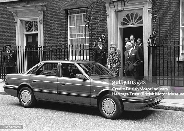 Margaret Thatcher, Conservative Prime Minister, with her husband Denis Thatcher leaving Number 10 Downing Street where a new Rover 800 Sterling is...