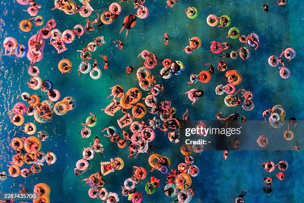 This aerial photo shows people cooling off at a water park amid hot weather in Nanjing, in eastern China's Jiangsu province on July 28, 2026. / China...