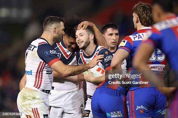 Sam Walker, James Tedesco and Naufahu Whyte of the roosters celebrate their win during the round 21 NRL match between Newcastle Knights and Sydney...