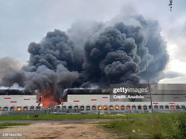 Smoke rises as firefighters work to extinguish a fire at Wildberries logistics hub following a Ukrainian drone attack in the Ryazan region of Russia...