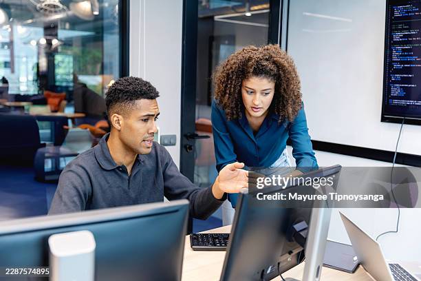 programmers solving software development challenges through collaborative code review - devops stock pictures, royalty-free photos & images