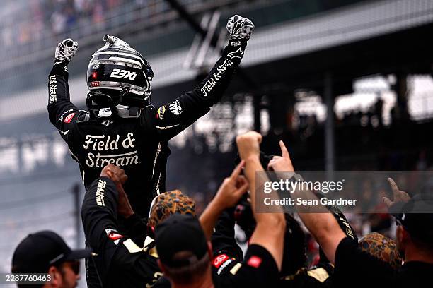 Corey Heim, driver of the Field & Stream Toyota, celebrates after winning the NASCAR Cup Series Brickyard 400 at Indianapolis Motor Speedway on July...