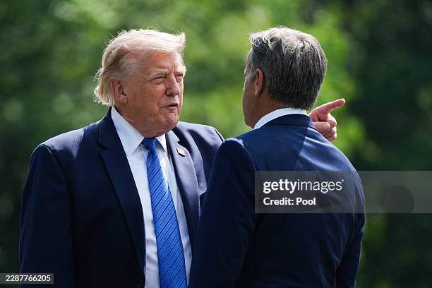 President Donald Trump and John Ratcliffe, Director of the Central Intelligence Agency , speak as they depart after a Cabinet meeting at Camp David...