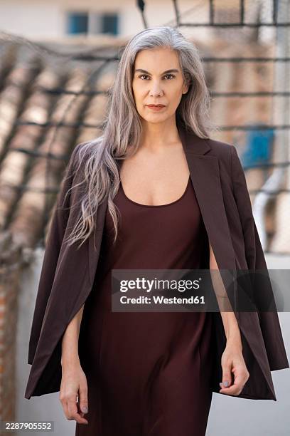 confident mature woman with grey hair in brown blazer outdoors - brown dress stock pictures, royalty-free photos & images