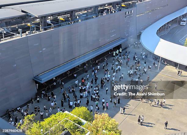 People stand outside JR Kumamoto Station after the magnitude 7.1 strong earthquake hit the region on July 28, 2026 in Kumamoto, Japan. A tsunami...