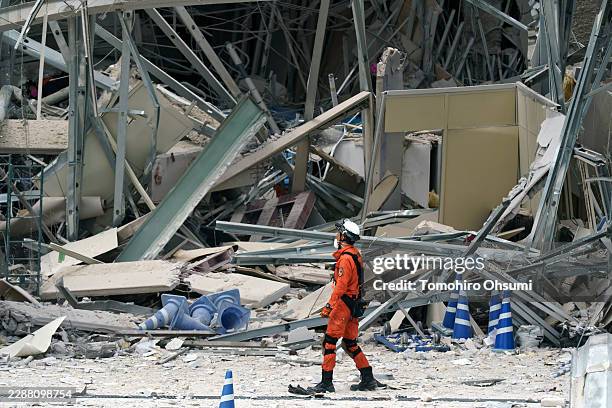 Firefighter searches for missing people at Aeon Mall Kumamoto which was damaged by an explosion following an earthquake on July 29, 2026 in Kashima,...