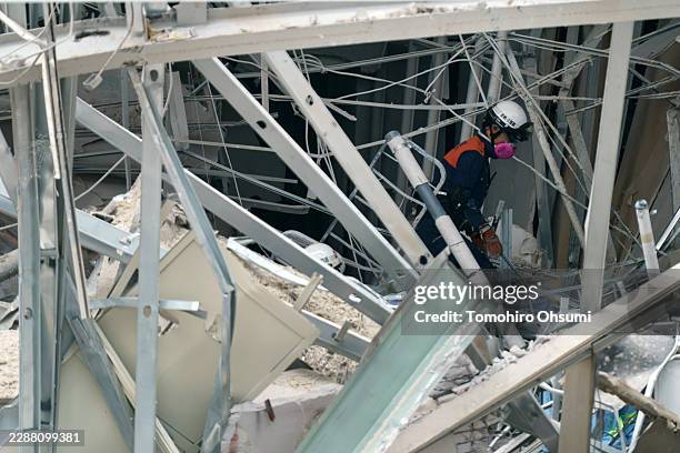 Firefighter searches for missing people at Aeon Mall Kumamoto which was damaged by an explosion following an earthquake on July 29, 2026 in Kashima,...
