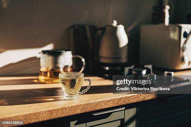 steaming hot tea with a single tea bag - dunking teabag stock pictures, royalty-free photos & images