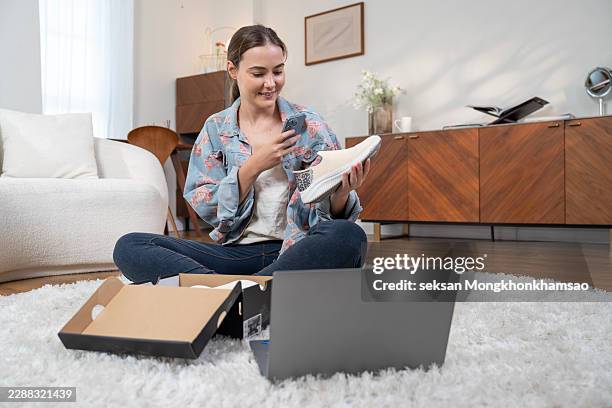 female customer taking photo the shoes with smartphone after unpack delivery box to check the product she ordered online shopping. - contactless delivery stock pictures, royalty-free photos & images