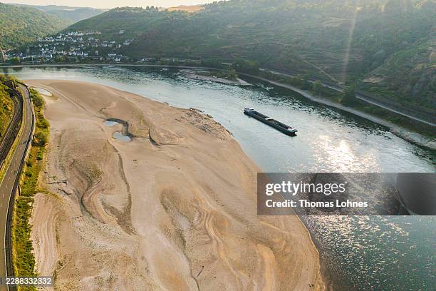 An aerial view as a cargo ship passes a huge exposed sandbar on the Rhine River during ongoing drought and a new heat wave on July 30, 2026 near...