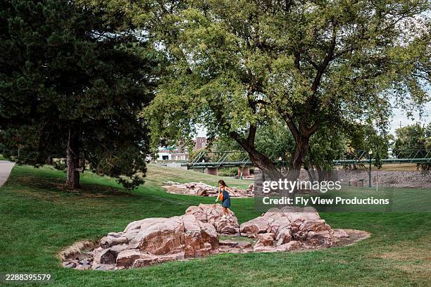 child exploring rock structures in sioux falls park - sioux falls stock pictures, royalty-free photos & images
