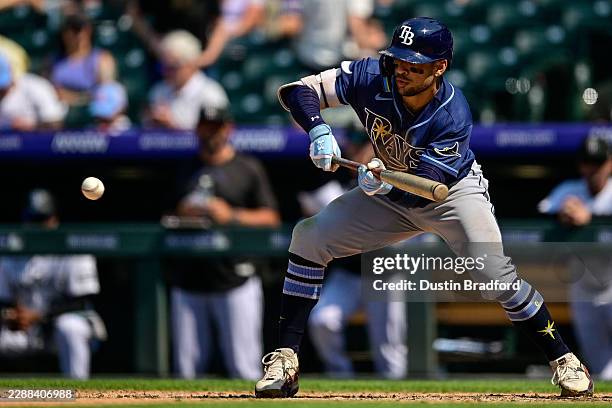 Victor Mesa Jr. #25 of the Tampa Bay Rays lays down an RBI sacrifice bunt in the seventh inning against the Colorado Rockies at Coors Field on August...