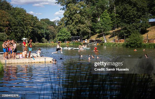 Festival goers swim in Lake Wilderness during the 2026 Wilderness Festival on July 31, 2026 in Charlbury, Oxfordshire.