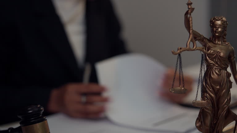 https://media.gettyimages.com/id/2288514260/video/scales-of-justice-symbol-with-attorney-reviewing-legal-paperwork-in-office.jpg?b=1&s=640x640&k=20&c=4DSlIGF1lH14x4s6XIZIYzX7cE0MOkqj3nELkNwkGr8=