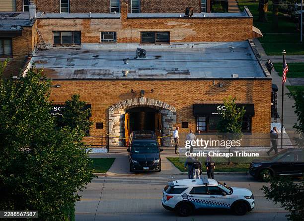 Officials work outside South Chicago Chapel funeral home where dozens of bodies were found on Thursday, Aug. 6 in Chicago.