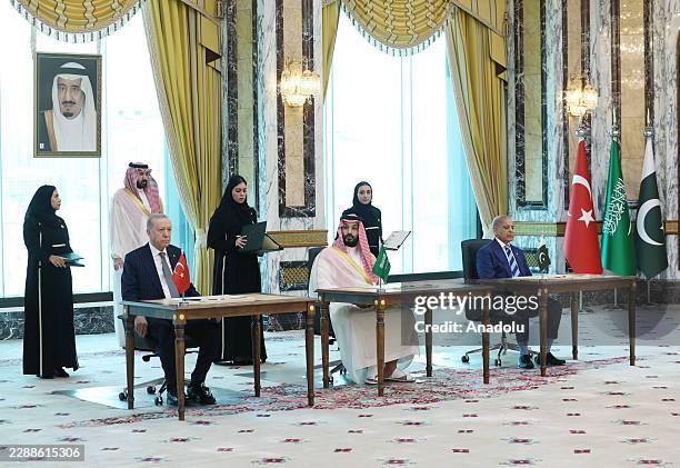 Turkish President Recep Tayyip Erdogan , Saudi Crown Prince Mohammed bin Salman , and Pakistani Prime Minister Shehbaz Sharif sign a trilateral...