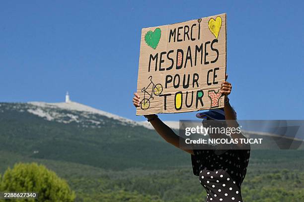 Bystander raises a placard reading "Thank you, ladies, for this Tour" with the Mont Ventoux in the background during the 7th stage of the fifth...