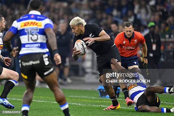 New Zealand's wing Rieko Ioane is tackled during a rugby union tour match between the Stormers and New Zealand at the Cape Town Stadium in Cape Town...