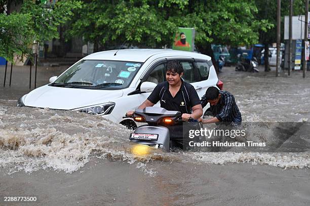 Vehicles wade through a waterlogged stretch following heavy monsoon rainfall on the sector-10 road near Euro International School on August 7, 2026...