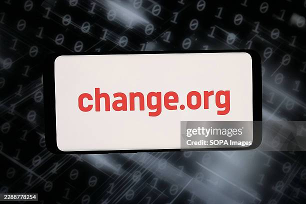 In this photo illustration, the US online petitions platform Change.org PBC logo is seen displayed on a smartphone in front of abstract background on...