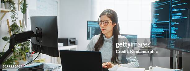 asian female software engineer developer use laptop computer at home office, work on program coding. programming language development technology, freelance woman work from home concept - computer programmer stock pictures, royalty-free photos & images