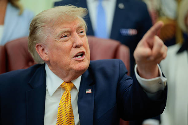 President Donald Trump speaks to the media after signing an executive order establishing the President's Military Spouse Commission in the Oval...