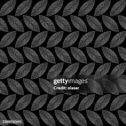 Black and white repeating leaf-like dot pattern arranged in diagonal rows on a dark background. Black and white repeating leaf-like dot pattern arranged in diagonal rows on a dark background.