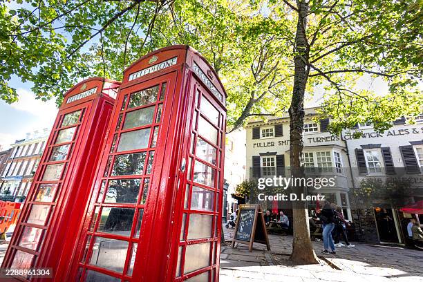 red telephone boxes beneath autumn trees, richmond - richmond upon thames stock pictures, royalty-free photos & images