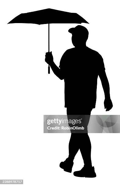 man walking with umbrella silhouette - baseball cap white background stock illustrations