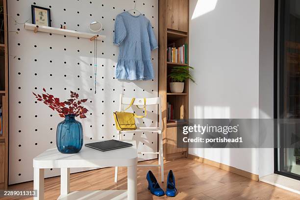 modular pegboard wall organizer in small contemporary studio apartmen - pegboard texture stock pictures, royalty-free photos & images