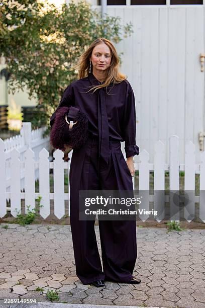 Laura Schulte wears purple button shirt, pants, bag outside Gestuz during the Copenhagen Fashion Week Spring/Summer 2027 on August 04, 2026 in...
