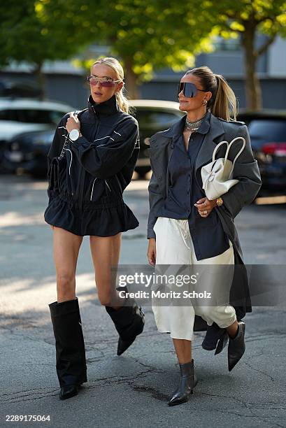Josefien Weyns is seen wearing a black oversized high neck zip front technical jacket with white contrast piping; black micro shorts; black leather...