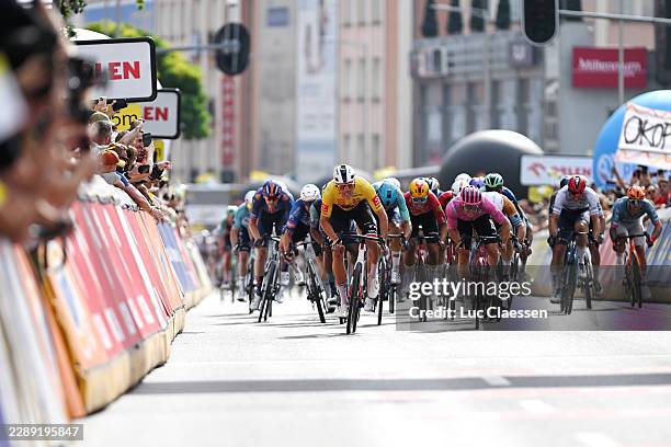 Jonathan Milan of Italy and Team Lidl - Trek - Yellow leader jersey and Noah Hobbs of Great Britain and Team EF Education - EasyPost sprint at finish...