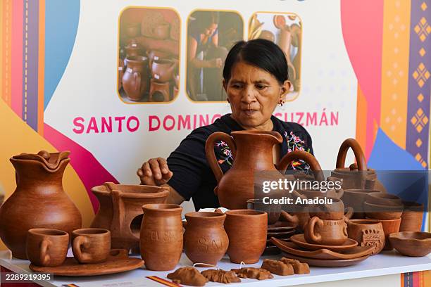 An indigenous woman selling clay handicrafts during the Celebration of the National and International Day of Indigenous Peoples in the Historic...