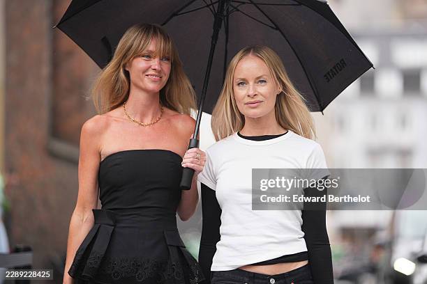 Jeanette Friis Madsen wears long straight blonde hair with bangs, a black strapless bandeau top with lace trim, black balloon pants; Thora Valdimars...