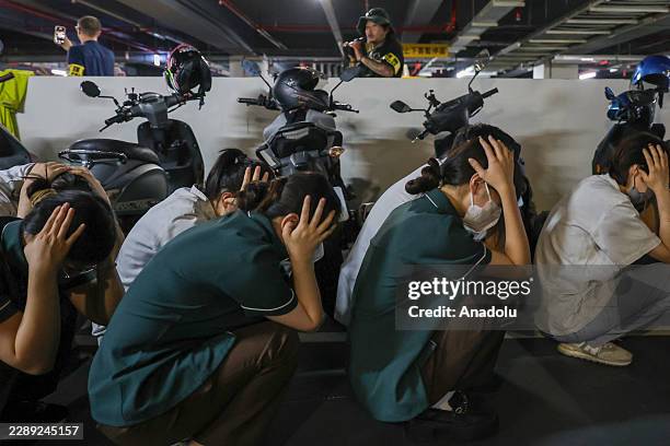 People take the brace position at an underground car park during an air-raid drill as part of the Civil Defence Urban Resilience exercise, in...