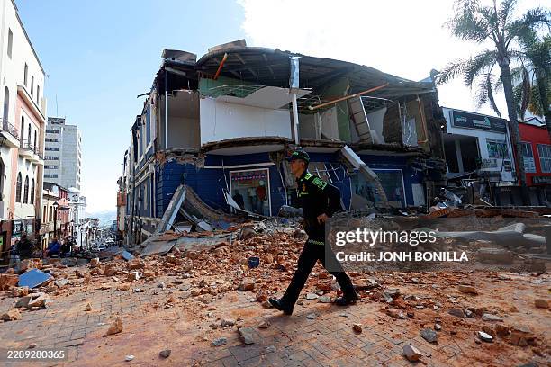 Police officer walks amid the debris of a damaged commercial store after the earthquake in Manizales, Colombia, on August 10, 2026. A strong...