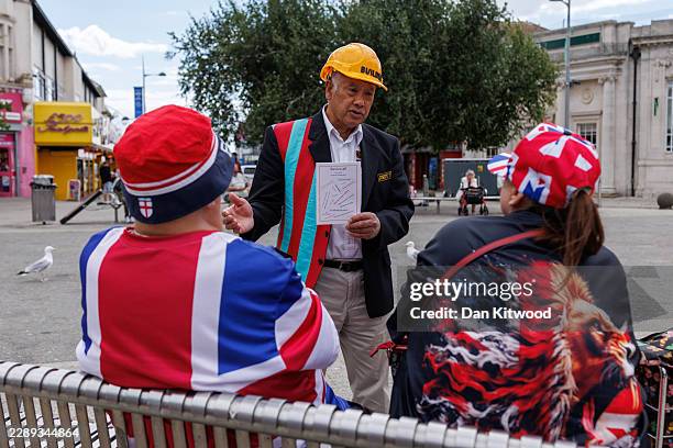 Independent candidate Joseph 77, speaks with members of the public in the town square on August 06, 2026 in Clacton-on-Sea, England. The Clacton...