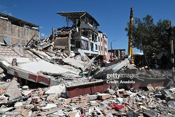 Residents and rescue workers carry out search, rescue and evacuation operations after a powerful earthquake struck Colombia, killing at least 18...