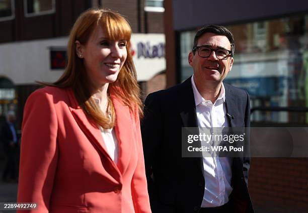 Prime Minister Andy Burnham and UK Housing Secretary Angela Rayner react as they walk past shops during a visit on August 11, 2026 in Ilkeston,...