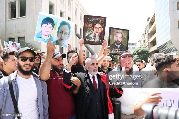 Syrians gather around the Palace of Justice to celebrate a court's death sentences against ousted leader Bashar al-Assad, his brother Maher al-Assad...