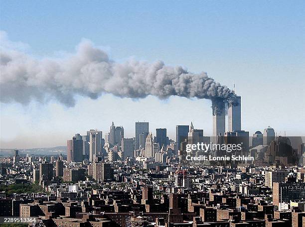 View of the Twin Towers after they were struck by planes flown by Al Qaida terrorists, as viewed from 37th floor of the southern most building of...