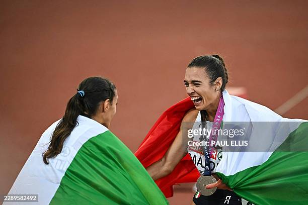 Gold medallist Italy's Nadia Battocletti and bronze medallist Italy's Micol Majori celebrate after competing in the women's 5000m final during the...